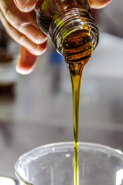 olive oil dripping out of bottle